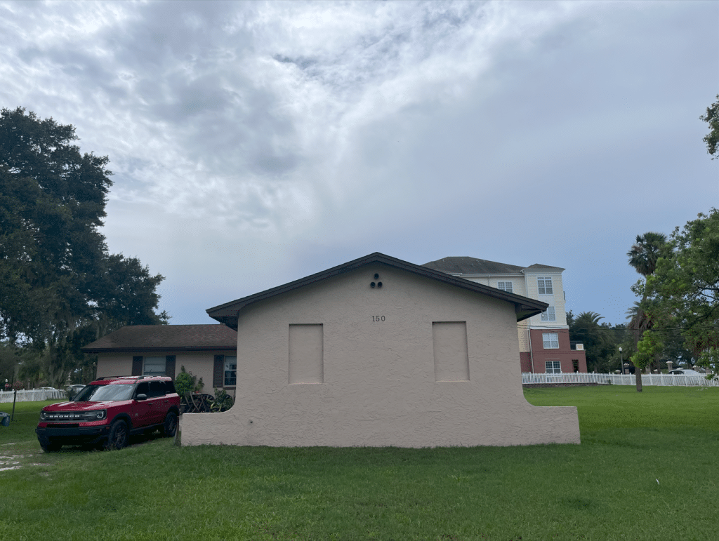 An image shows the Kingsbury house with the Winter Spprings Town Center in the background. 
