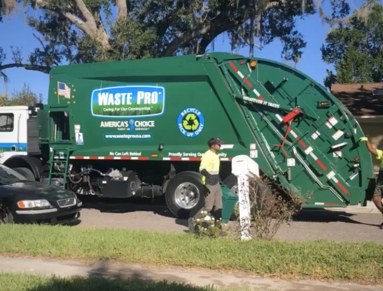 Waste Pro employees pick up recycling
