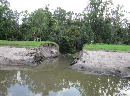 Photo of pond berm blowout flooding stormwater improvements