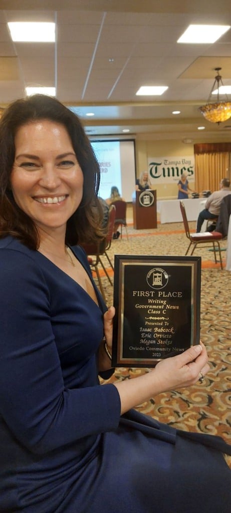 Editor-in-chief Megan Stokes shows one of the newsroom's first-place awards.