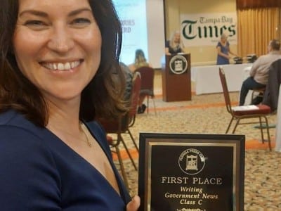 Editor-in-chief Megan Stokes shows one of the newsroom's first-place awards.