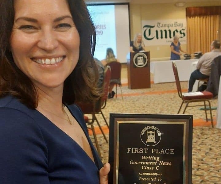 Editor-in-chief Megan Stokes shows one of the newsroom's first-place awards.