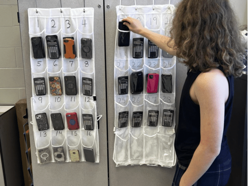 Sophomore Jasper Thompson puts his phone in his assigned pocket in Mrs. Grasso’s room.