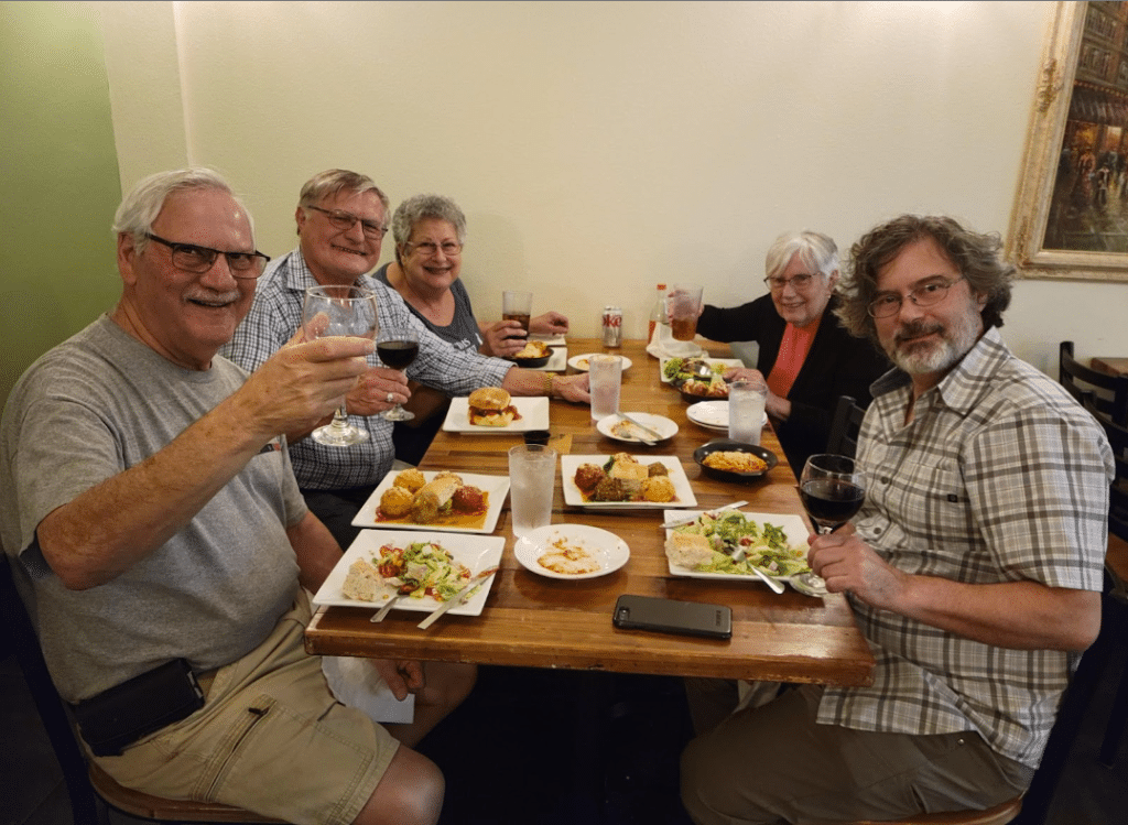 Dennis Dulniak (left, center) enjoys a Dementia-Friendly Dining experience at The Meatball Stoppe.