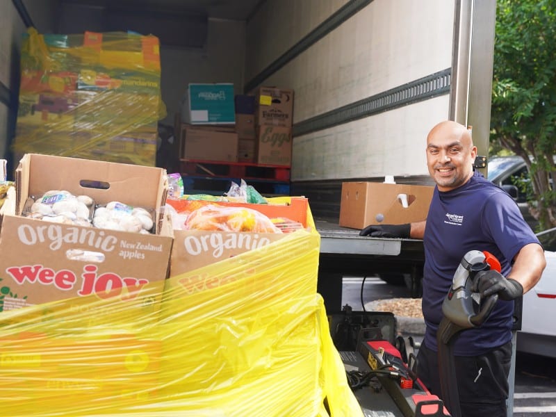 Delivery truck driver picking up groceries for food bank